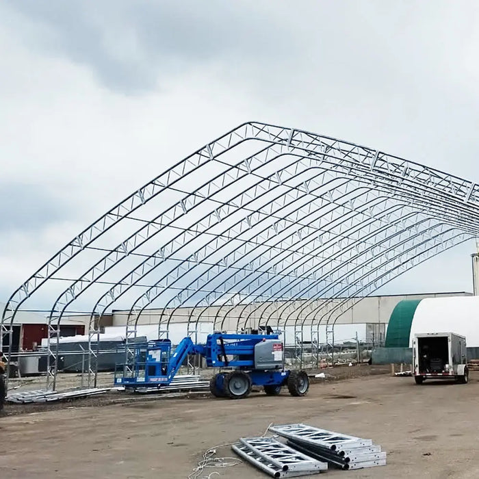 TMG Industrial Pro Series 70' x 100' Dual Truss Storage Shelter with Heavy Duty 32 oz PVC Cover & Drive Through Doors, TMG-DT70100-PRO